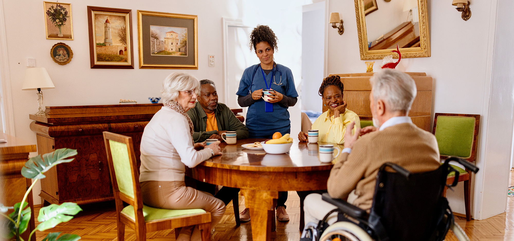 Group of people socializing around a table, enjoying conversation.